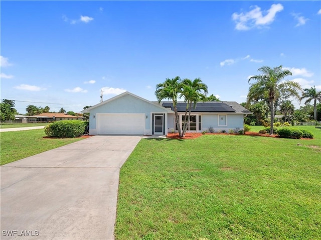 505 Monterey Ave, Cape Coral, FL 33904 - ranch-style home with an attached garage, concrete driveway, solar panels, a front lawn, and stucco siding