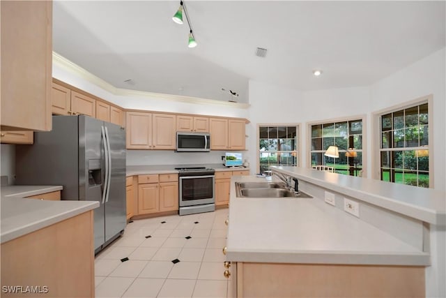 858 Wyndemere Way, Naples, FL 34105 - kitchen with stainless steel appliances, light brown cabinetry, light countertops, light tile patterned floors, and a center island with sink