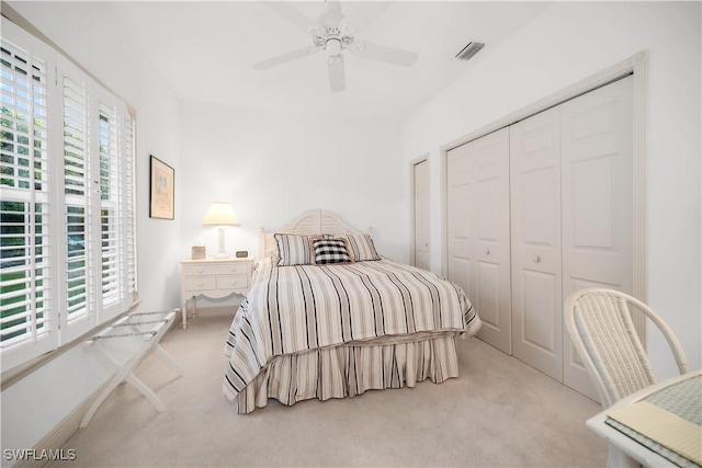 858 Wyndemere Way, Naples, FL 34105 - carpeted bedroom with multiple windows, a closet, and a ceiling fan