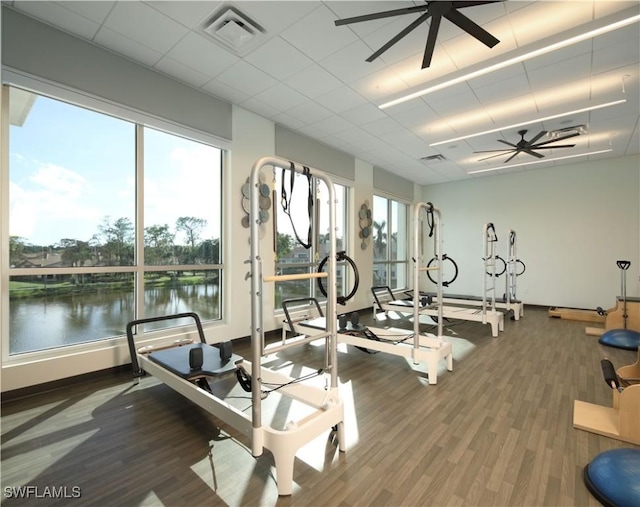 858 Wyndemere Way, Naples, FL 34105 - exercise room with a ceiling fan, wood finished floors, a drop ceiling, and a water view