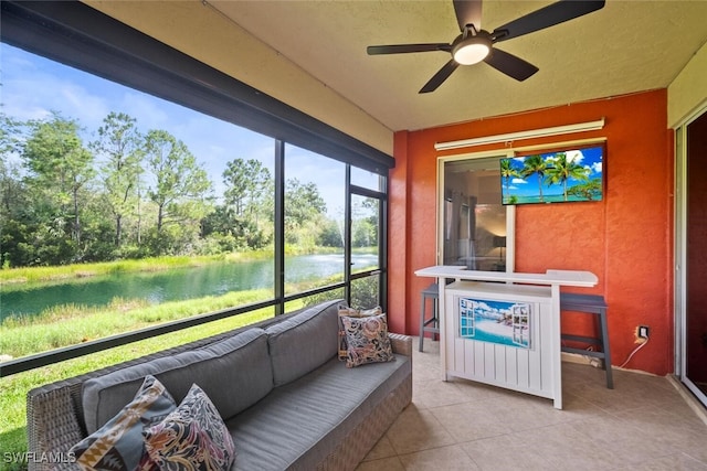 8701 Piazza Del Lago Cir Unit 101, Estero, FL 33928 - sunroom / solarium featuring ceiling fan, outdoor lounge area, and view of wooded area