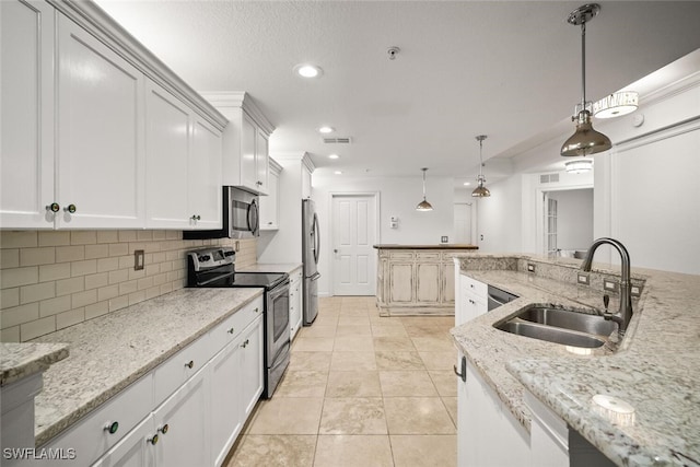 8701 Piazza Del Lago Cir Unit 101, Estero, FL 33928 - kitchen with appliances with stainless steel finishes, recessed lighting, tasteful backsplash, light stone counters, and decorative light fixtures