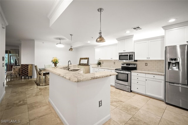 8701 Piazza Del Lago Cir Unit 101, Estero, FL 33928 - kitchen with stainless steel appliances, backsplash, light stone counters, white cabinets, and recessed lighting