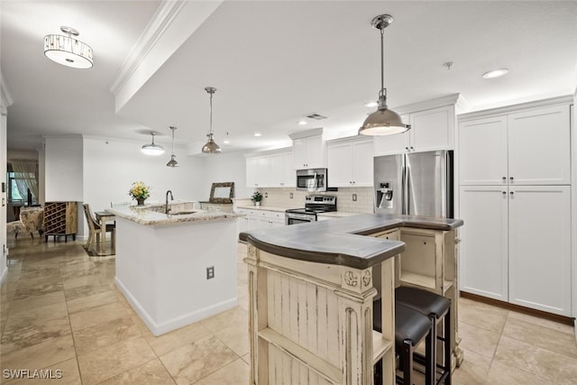 8701 Piazza Del Lago Cir Unit 101, Estero, FL 33928 - kitchen with stainless steel appliances, a center island with sink, ornamental molding, tasteful backsplash, and recessed lighting