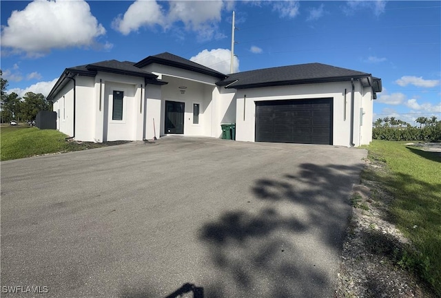 4067 33rd Ave NE, Naples, FL 34120 - view of front of home featuring a garage, stucco siding, driveway, and a front lawn