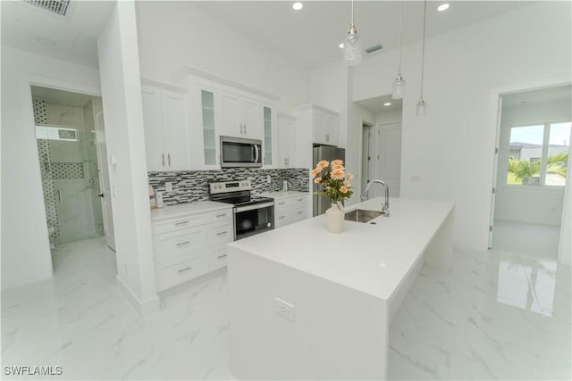 3923 NW 38th St, Cape Coral, FL 33993 - kitchen featuring stainless steel appliances, light marble finish flooring, recessed lighting, decorative backsplash, and white cabinetry