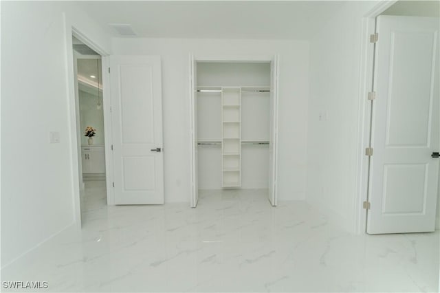 3923 NW 38th St, Cape Coral, FL 33993 - unfurnished bedroom featuring marble look tile flooring and a closet