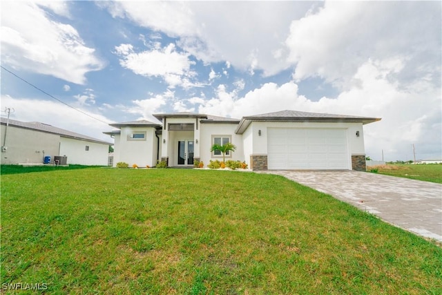 3923 NW 38th St, Cape Coral, FL 33993 - prairie-style home featuring decorative driveway, stucco siding, a garage, and a front yard