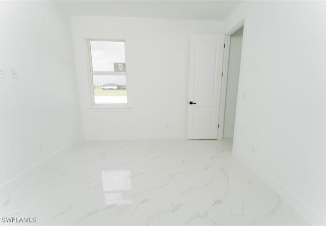 3923 NW 38th St, Cape Coral, FL 33993 - unfurnished room featuring marble look tile flooring and baseboards