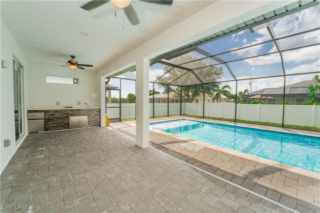 3923 NW 38th St, Cape Coral, FL 33993 - view of pool featuring ceiling fan, a patio area, glass enclosure, and exterior kitchen