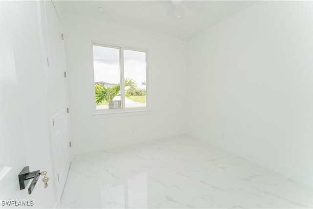 3923 NW 38th St, Cape Coral, FL 33993 - empty room featuring marble finish floors and baseboards