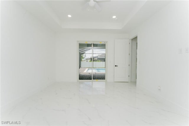 3923 NW 38th St, Cape Coral, FL 33993 - empty room with a tray ceiling, marble finish flooring, ceiling fan, and recessed lighting