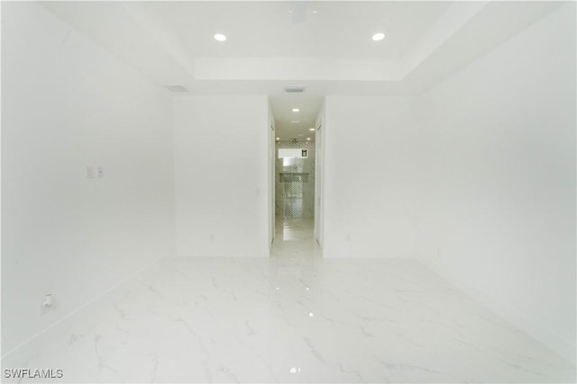 3923 NW 38th St, Cape Coral, FL 33993 - spare room with a raised ceiling, marble finish floors, and recessed lighting