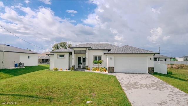 3923 NW 38th St, Cape Coral, FL 33993 - prairie-style home with decorative driveway, an attached garage, stucco siding, stone siding, and french doors