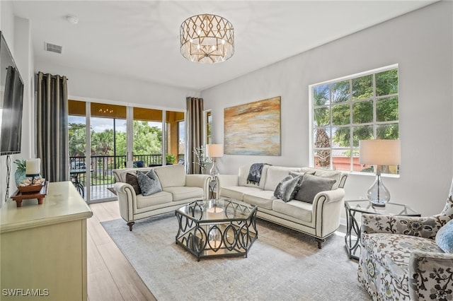 8608 Via Rapallo Dr Unit 206, Estero, FL 33928 - living room with light wood-style floors and a chandelier