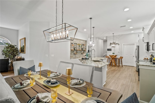 8608 Via Rapallo Dr Unit 206, Estero, FL 33928 - dining area featuring light wood-style flooring, a chandelier, and recessed lighting