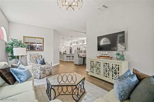 8608 Via Rapallo Dr Unit 206, Estero, FL 33928 - living room with wood finished floors, a chandelier, and recessed lighting