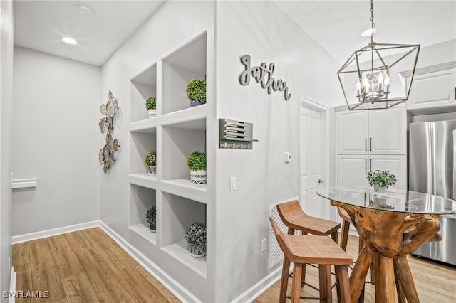 8608 Via Rapallo Dr Unit 206, Estero, FL 33928 - dining room featuring a chandelier, light wood finished floors, built in features, and recessed lighting
