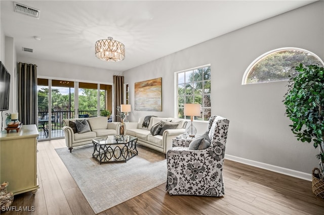 8608 Via Rapallo Dr Unit 206, Estero, FL 33928 - living room with a chandelier and wood finished floors