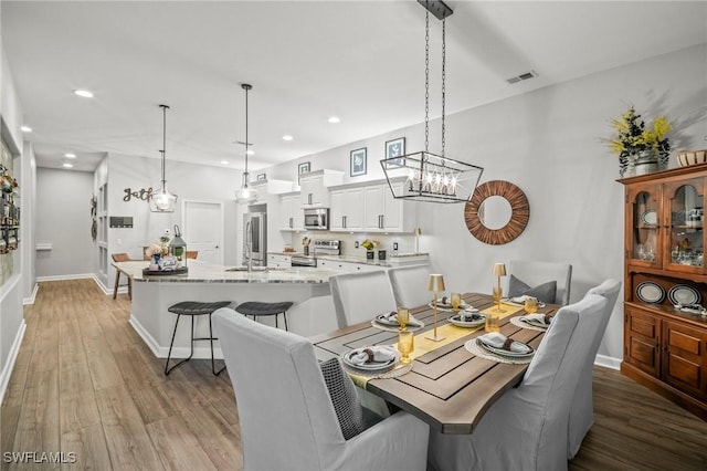 8608 Via Rapallo Dr Unit 206, Estero, FL 33928 - dining space featuring light wood finished floors, recessed lighting, and a chandelier
