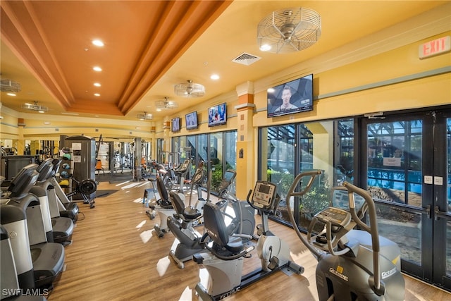 8608 Via Rapallo Dr Unit 206, Estero, FL 33928 - workout area featuring a raised ceiling, crown molding, recessed lighting, and wood finished floors