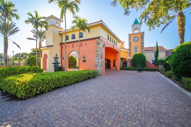 8608 Via Rapallo Dr Unit 206, Estero, FL 33928 - mediterranean / spanish-style home featuring stucco siding and curved driveway