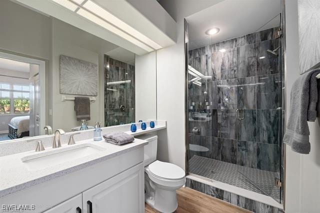 8608 Via Rapallo Dr Unit 206, Estero, FL 33928 - bathroom with vanity, a stall shower, connected bathroom, and wood finished floors