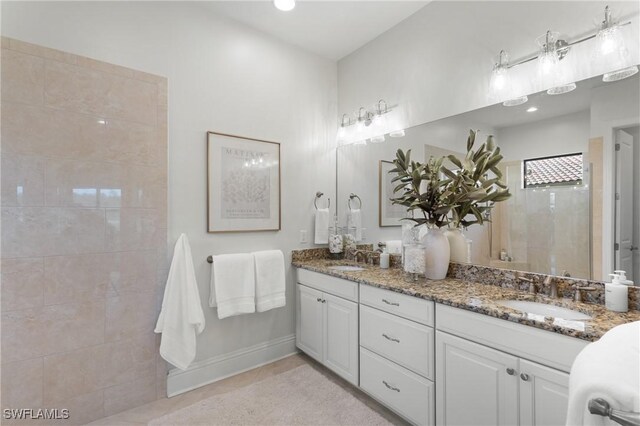 8888 Savona Ct, Naples, FL 34119 - bathroom with double vanity, tiled shower, tile patterned floors, and recessed lighting