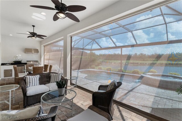 8888 Savona Ct, Naples, FL 34119 - sunroom / solarium featuring exterior kitchen, a ceiling fan, and healthy amount of natural light