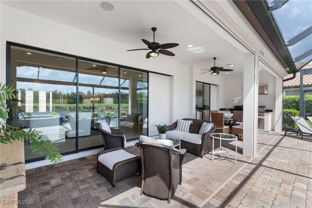 8888 Savona Ct, Naples, FL 34119 - view of patio / terrace with ceiling fan, glass enclosure, exterior kitchen, and outdoor lounge area