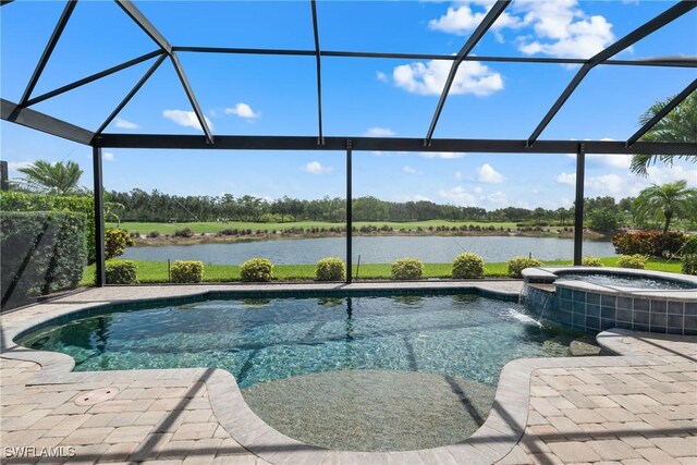 8888 Savona Ct, Naples, FL 34119 - view of swimming pool featuring a water view, a lanai, a patio, and a pool with connected hot tub