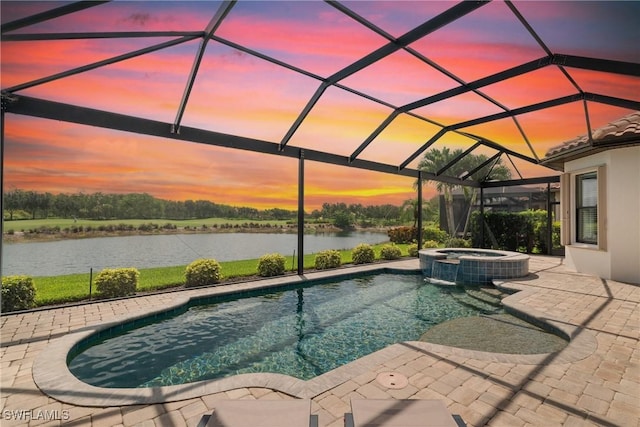 8888 Savona Ct, Naples, FL 34119 - pool at dusk with a water view, a patio area, a pool with connected hot tub, and a lanai