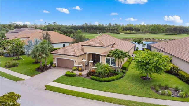 8888 Savona Ct, Naples, FL 34119 - view of front of property with stucco siding, an attached garage, a tiled roof, a front yard, and view of golf course