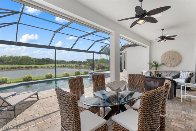 8888 Savona Ct, Naples, FL 34119 - view of patio with a water view, a ceiling fan, outdoor dining area, a lanai, and a pool with connected hot tub