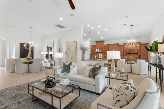 8888 Savona Ct, Naples, FL 34119 - living room with a chandelier, recessed lighting, and ornamental molding