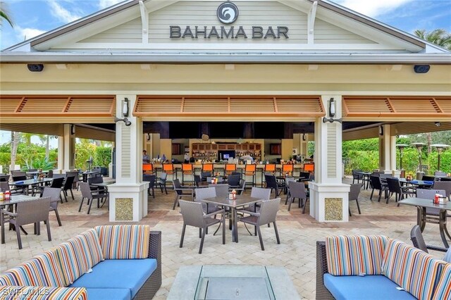 8888 Savona Ct, Naples, FL 34119 - view of patio featuring an outdoor living space and outdoor dining area