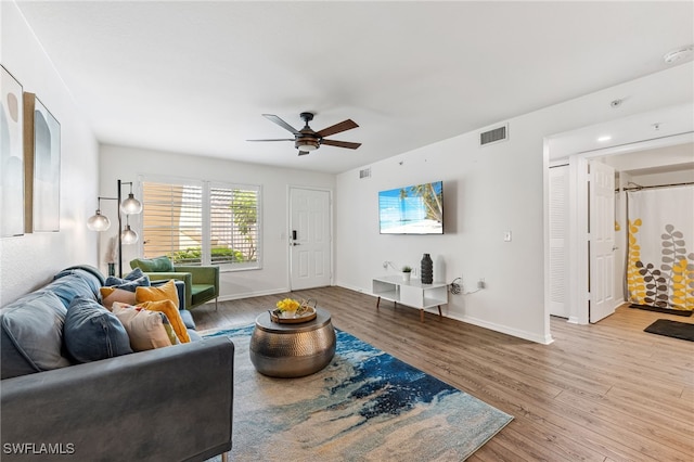 4940 Cougar Ct S Unit 104, Naples, FL 34109 - living area with ceiling fan and wood finished floors