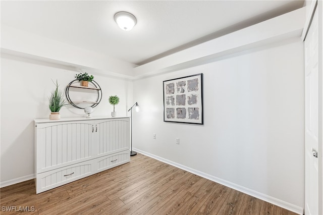 4940 Cougar Ct S Unit 104, Naples, FL 34109 - unfurnished bedroom with light wood finished floors and baseboards