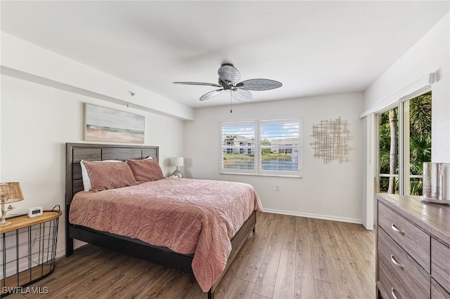 4940 Cougar Ct S Unit 104, Naples, FL 34109 - bedroom featuring wood-type flooring, access to outside, and a ceiling fan