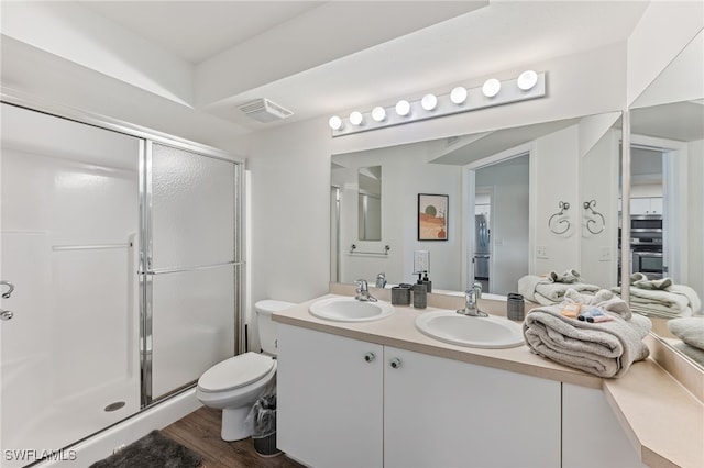 4940 Cougar Ct S Unit 104, Naples, FL 34109 - full bathroom featuring a stall shower, double vanity, and wood finished floors