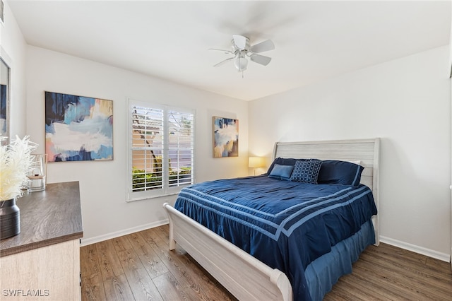 4940 Cougar Ct S Unit 104, Naples, FL 34109 - bedroom with wood finished floors and ceiling fan