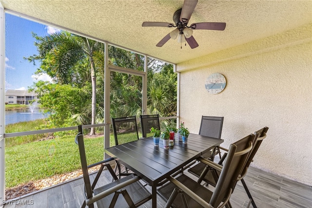 4940 Cougar Ct S Unit 104, Naples, FL 34109 - sunroom with a water view, a ceiling fan, and outdoor dining area
