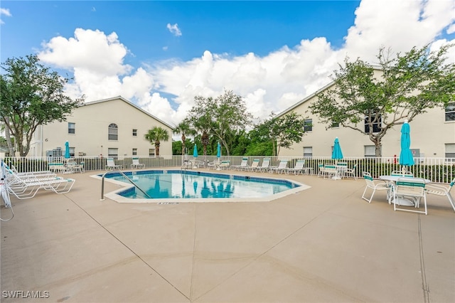 4940 Cougar Ct S Unit 104, Naples, FL 34109 - community pool featuring a patio