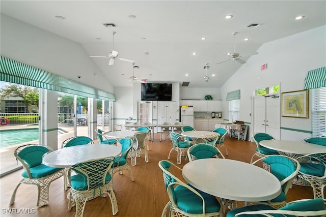 162 Pebble Shores Dr Unit 203, Naples, FL 34110 - dining room featuring high vaulted ceiling, ceiling fan, and wood finished floors