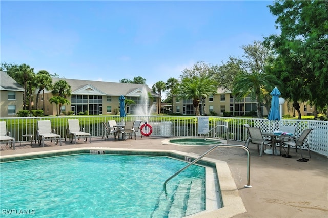 162 Pebble Shores Dr Unit 203, Naples, FL 34110 - community pool with a community hot tub and a patio