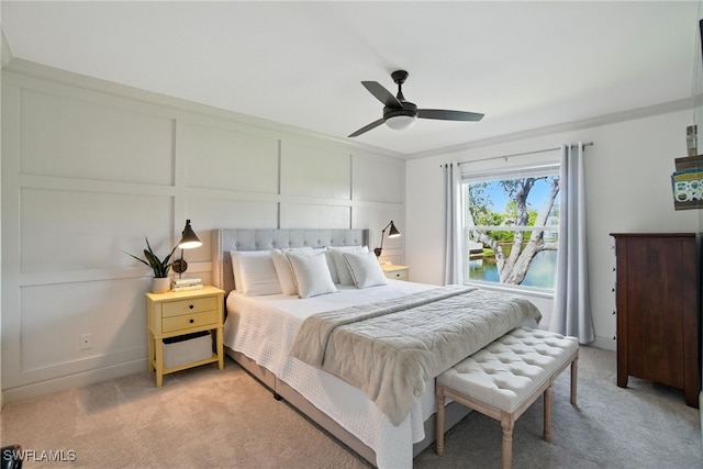 162 Pebble Shores Dr Unit 203, Naples, FL 34110 - bedroom with light colored carpet, a decorative wall, ornamental molding, a ceiling fan, and a water view