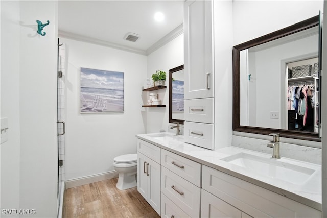 162 Pebble Shores Dr Unit 203, Naples, FL 34110 - full bathroom featuring double vanity, a shower stall, wood finished floors, crown molding, and a walk in closet
