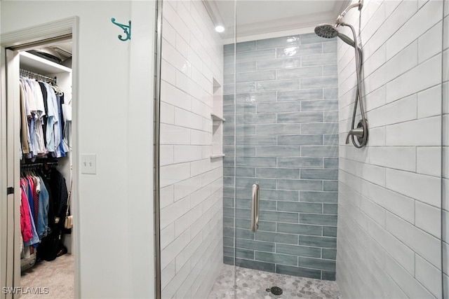 162 Pebble Shores Dr Unit 203, Naples, FL 34110 - bathroom with a stall shower, a spacious closet, and ornamental molding