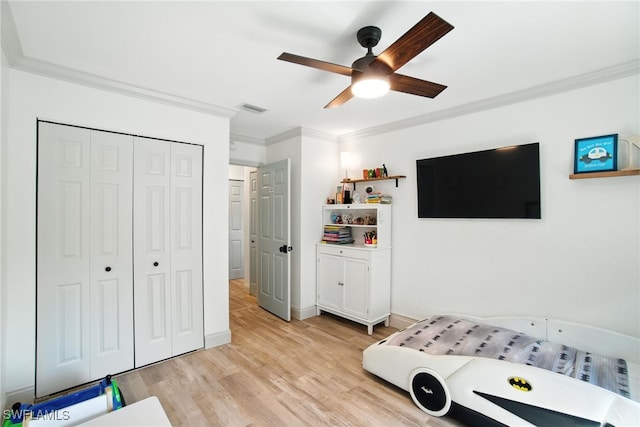 162 Pebble Shores Dr Unit 203, Naples, FL 34110 - bedroom with crown molding, light wood-style floors, a closet, and ceiling fan