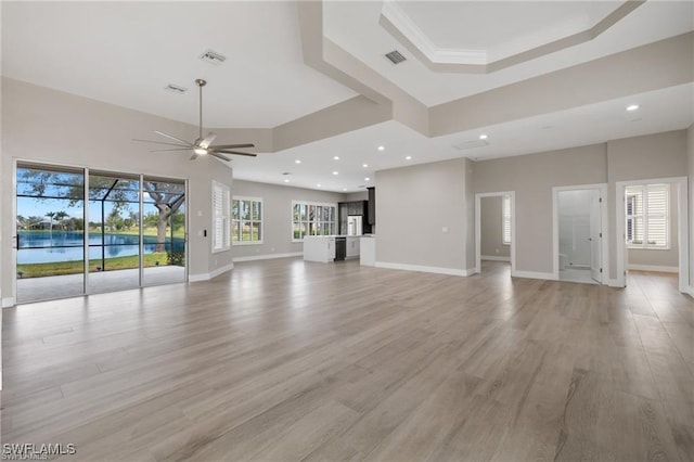 16409 Coco Hammock Way, Fort Myers, FL 34135 - unfurnished living room with ceiling fan, light wood-type flooring, recessed lighting, a raised ceiling, and a towering ceiling